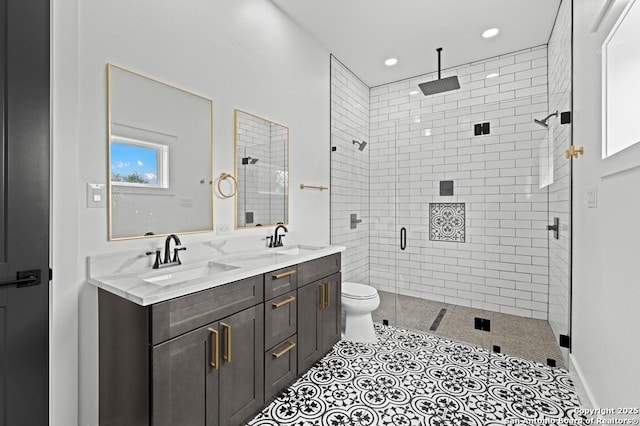 bathroom featuring tile patterned floors, vanity, toilet, and an enclosed shower