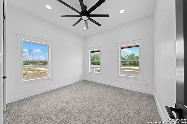 empty room with ceiling fan and carpet floors