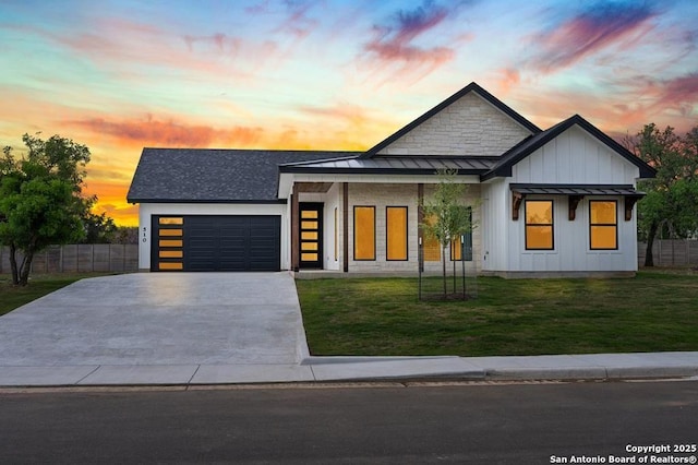 view of front of house with a yard and a garage