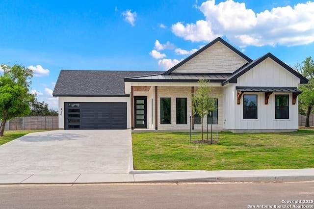 view of front of property with a garage and a front lawn