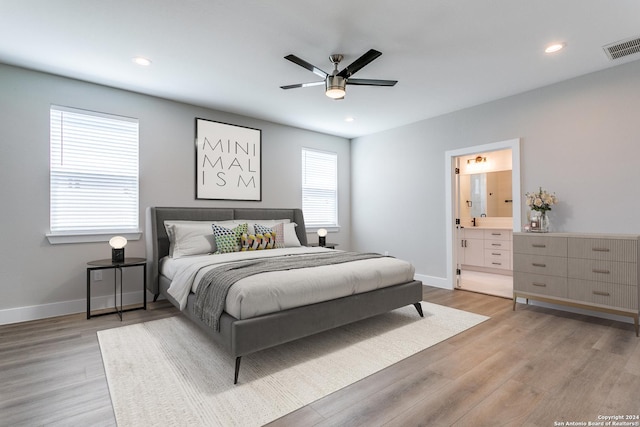 bedroom featuring light wood-type flooring, connected bathroom, and ceiling fan