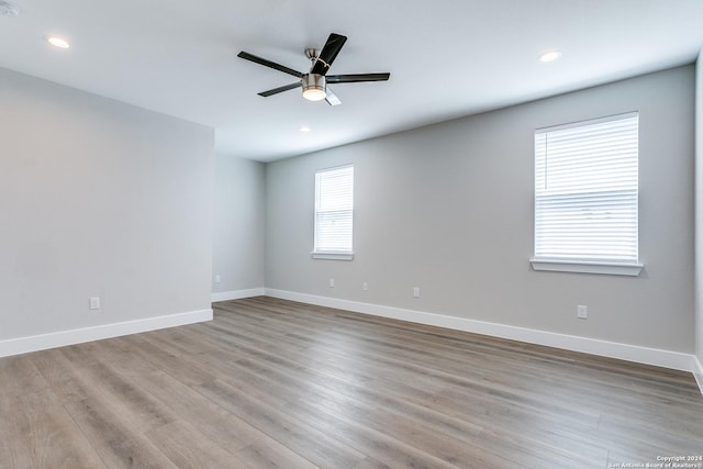 empty room featuring ceiling fan and light hardwood / wood-style floors