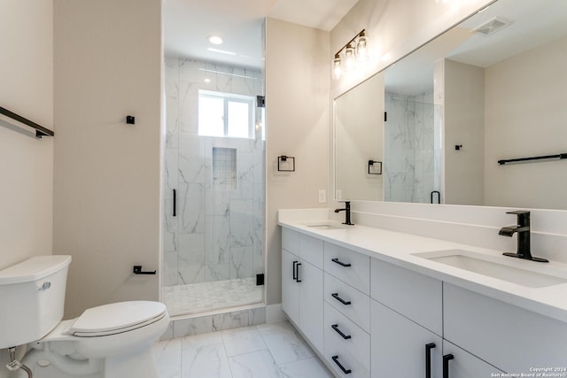 bathroom featuring a shower with door, vanity, and toilet