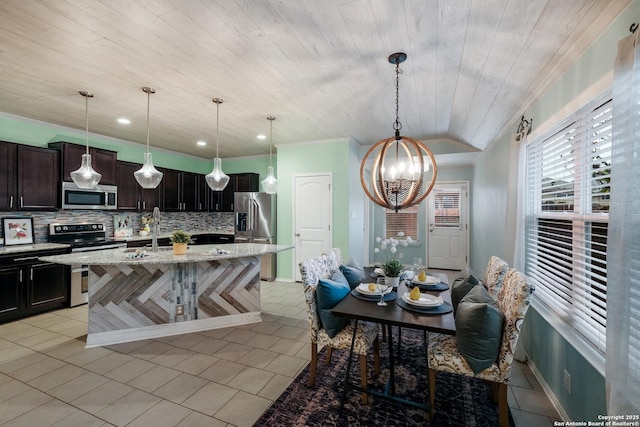 kitchen featuring stainless steel appliances, an island with sink, decorative light fixtures, decorative backsplash, and wood ceiling