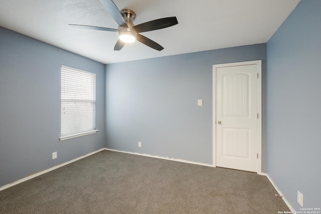 carpeted empty room featuring ceiling fan