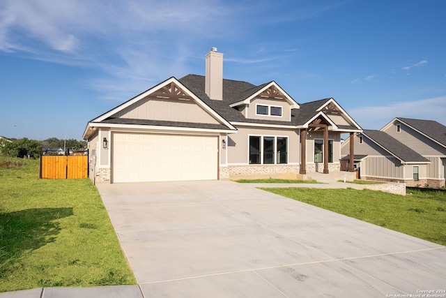 craftsman house with a garage and a front lawn