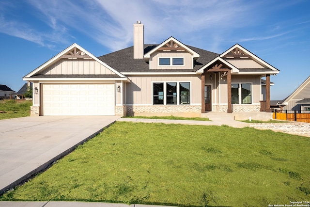 craftsman inspired home featuring a front yard and a garage