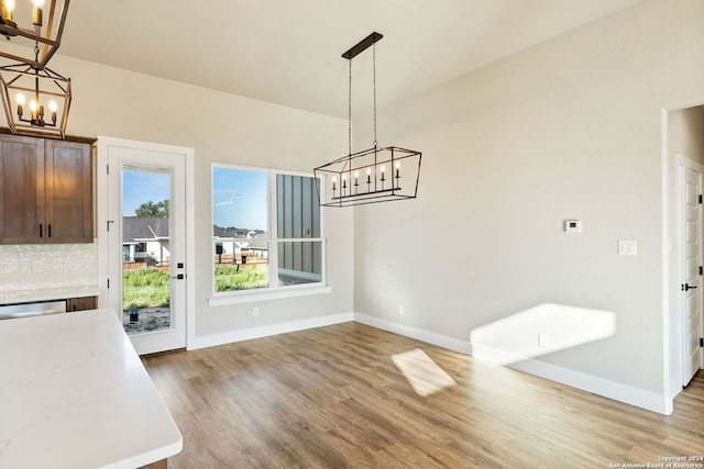 unfurnished dining area with light wood-type flooring