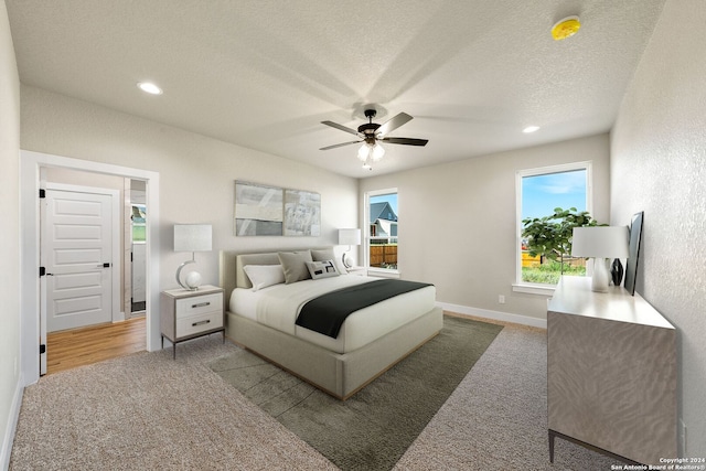 bedroom featuring ceiling fan, carpet floors, and a textured ceiling