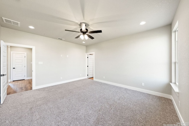 unfurnished room with light colored carpet and ceiling fan