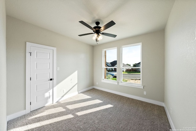 carpeted empty room with ceiling fan