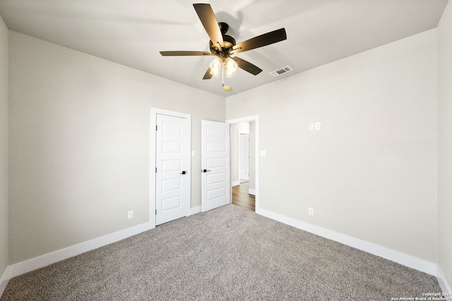 unfurnished bedroom featuring ceiling fan and carpet floors