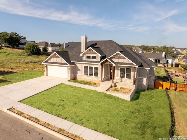 craftsman-style home featuring a front yard and a garage