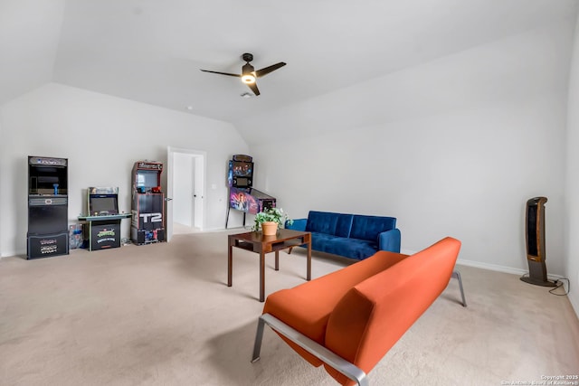 living area with carpet flooring, ceiling fan, and vaulted ceiling