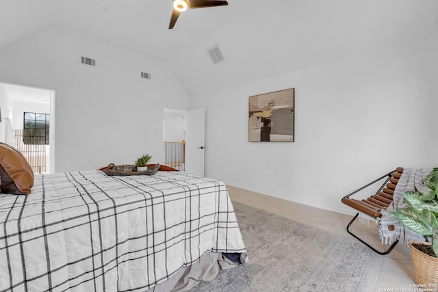 bedroom with ceiling fan, lofted ceiling, and light carpet