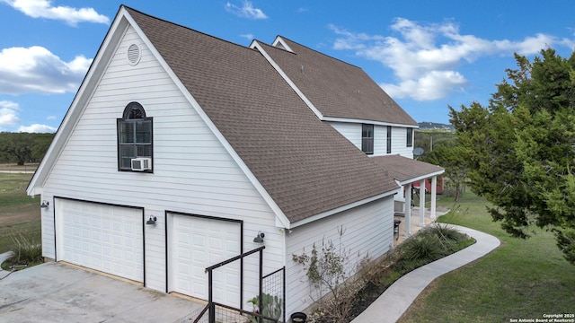 view of side of home with a lawn and a garage