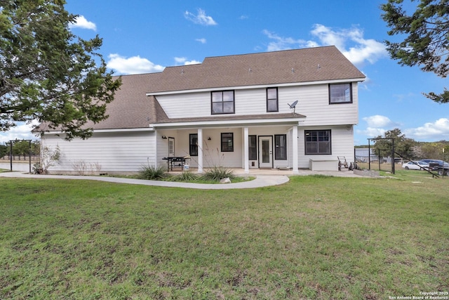 back of house with a lawn