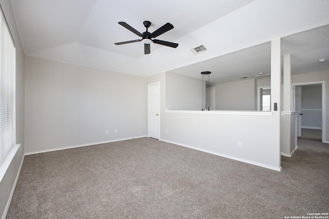 carpeted spare room with ceiling fan