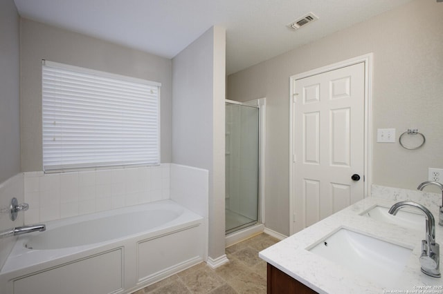 bathroom featuring vanity and shower with separate bathtub