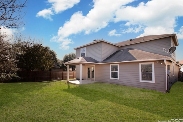 rear view of house with a lawn and a patio