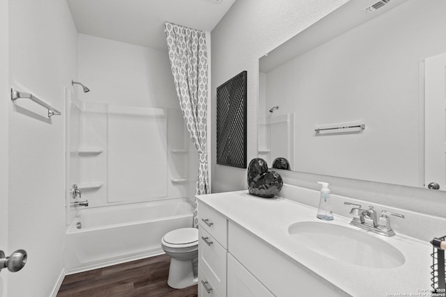 full bathroom featuring vanity, shower / bathtub combination with curtain, wood-type flooring, and toilet