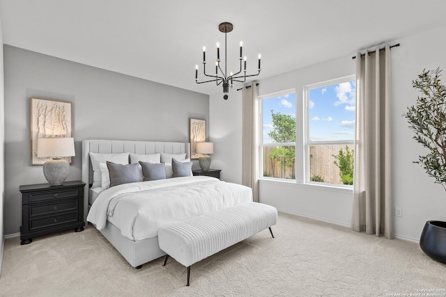 bedroom featuring light colored carpet and a chandelier