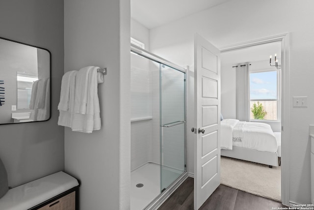 bathroom with hardwood / wood-style floors and walk in shower