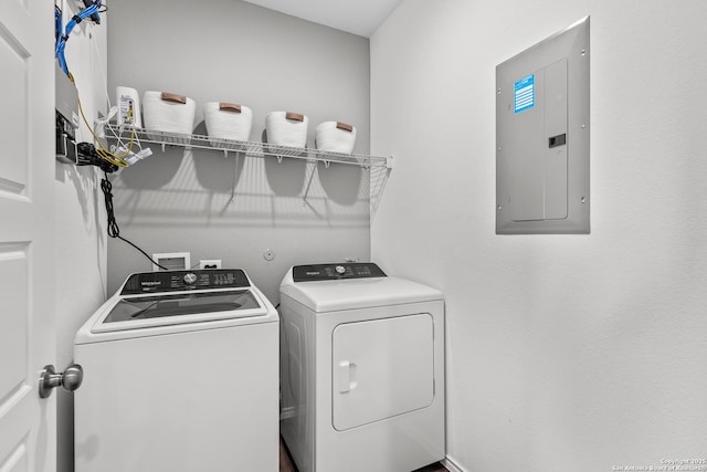 clothes washing area featuring electric panel and washing machine and clothes dryer