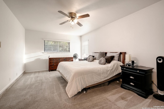 bedroom with ceiling fan and light carpet