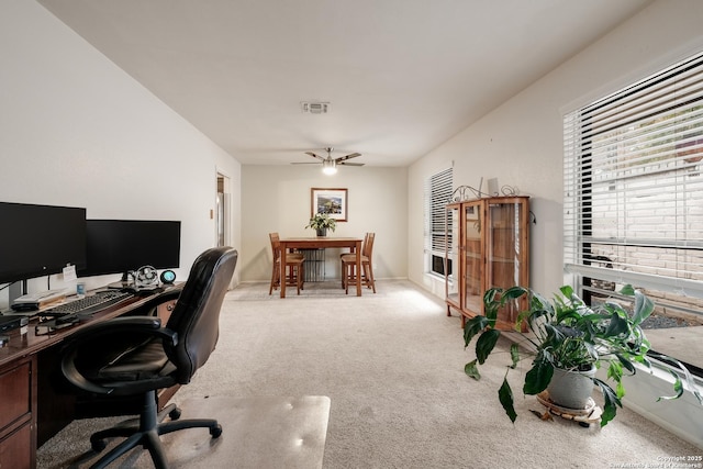 carpeted home office with ceiling fan