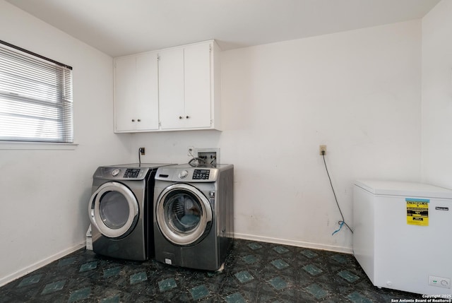 laundry area with cabinets and washing machine and clothes dryer