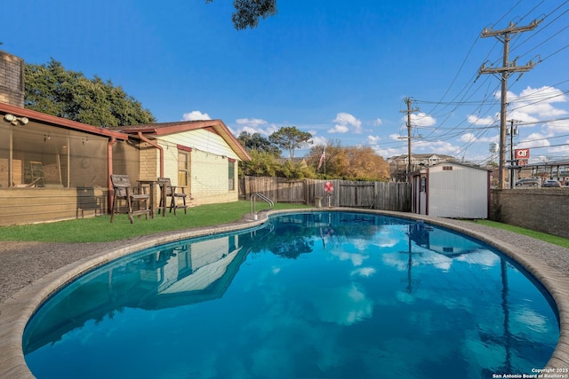 view of swimming pool featuring a storage shed