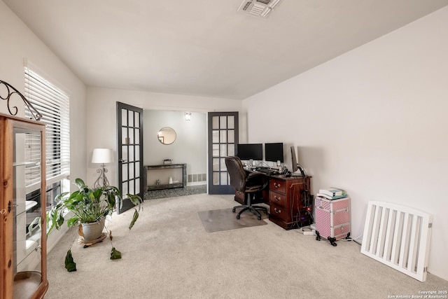 carpeted office featuring french doors