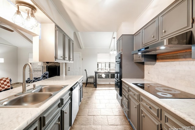 kitchen with black appliances, backsplash, sink, and hanging light fixtures