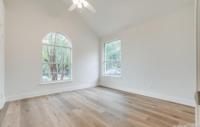 unfurnished room featuring a wealth of natural light, ceiling fan, high vaulted ceiling, and light wood-type flooring