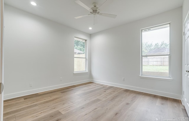 unfurnished room featuring light hardwood / wood-style flooring, ceiling fan, and a healthy amount of sunlight