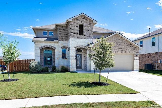 view of front of house with central AC unit, a garage, and a front lawn