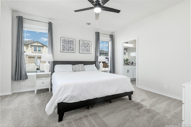 carpeted bedroom with connected bathroom and ceiling fan