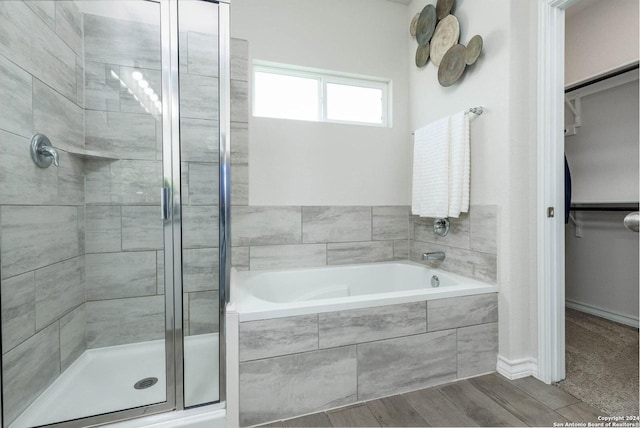 bathroom featuring separate shower and tub