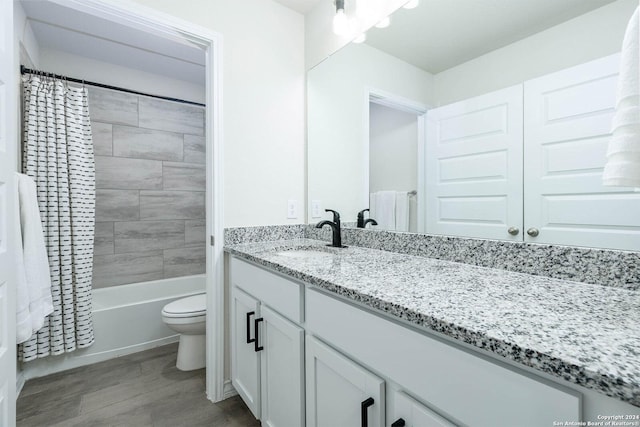 full bathroom with vanity, shower / bath combination with curtain, and toilet