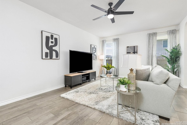 living room featuring ceiling fan and light hardwood / wood-style floors