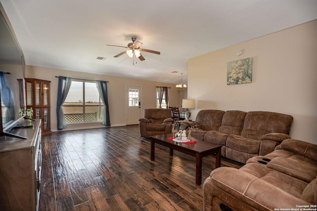 living room featuring dark hardwood / wood-style floors and ceiling fan with notable chandelier