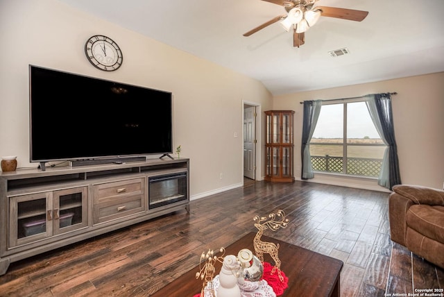 living room with dark hardwood / wood-style floors, vaulted ceiling, and ceiling fan