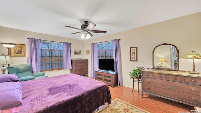 bedroom with ceiling fan and light hardwood / wood-style floors