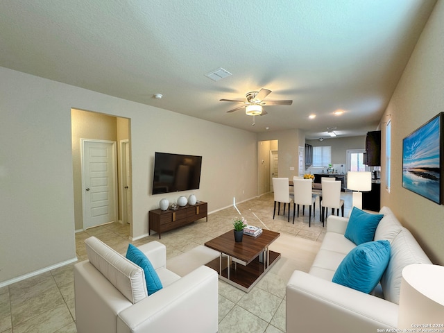 tiled living room with ceiling fan