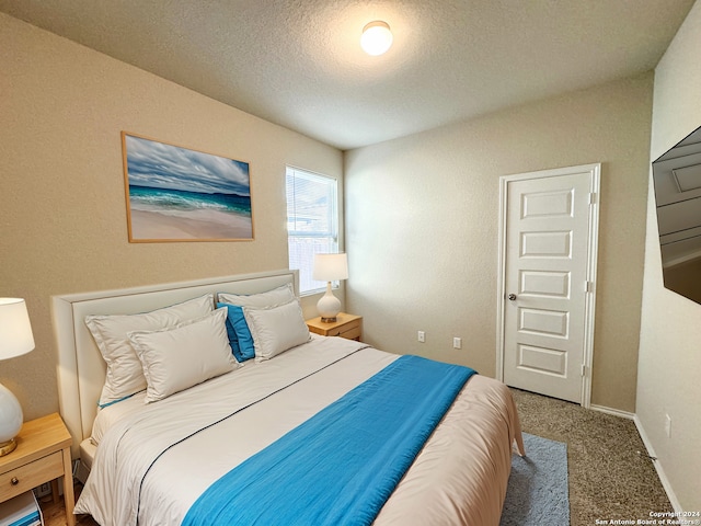 carpeted bedroom featuring a textured ceiling