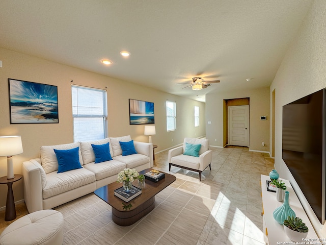 tiled living room with ceiling fan