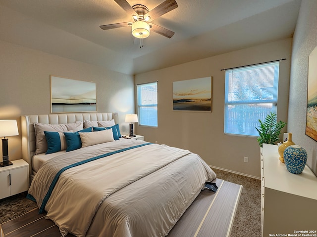 carpeted bedroom featuring vaulted ceiling and ceiling fan