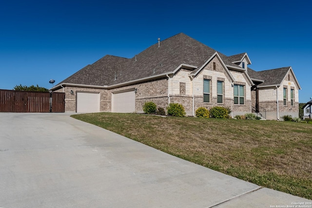 view of front of home featuring a garage and a front lawn