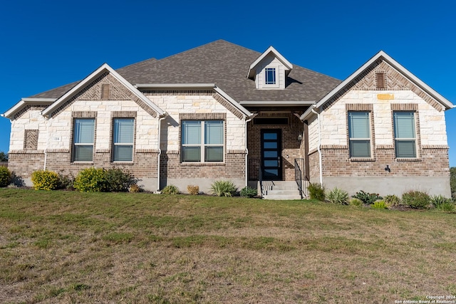 craftsman-style house with a front lawn